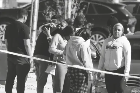  ?? H.W. CHIU
AP PHOTO/RINGO ?? Neighbors react near a home where five bodies were found dead, in the city of Lancaster in the high desert Antelope Valley north of Los Angeles on Monday. A Los Angeles County Sheriff’s Department statement says deputies found a woman, a girl and three boys with gunshot wounds and paramedics pronounced them dead at the scene. The department says the children’s father showed up at the Lancaster sheriff’s station and was arrested on suspicion of five murders after being interviewe­d by detectives.