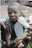  ?? SUNDAY ALAMBA THE ASSOCIATED PRESS ?? A child covered in dust is rescued from the rubble of a collapsed building Wednesday.