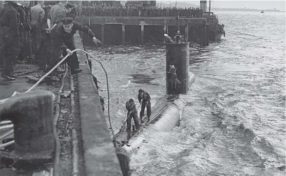  ??  ?? Roderick Stewart has provided this photograph of U 2326 berthing at the Western Wharf, Dundee, watched by an interested crowd. See more on left.