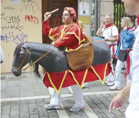  ??  ?? A Zaldiko (a horse with a rider) plays with kids on the streets. He carries a soft foam truncheon and pretends to hit the pedestrian­s.