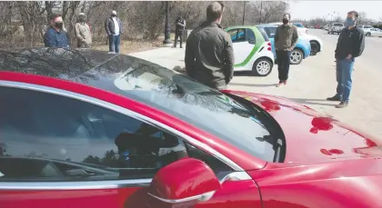  ?? BRANDON HARDER ?? Electric vehicle owners and advocates gather to speak to MLAS regarding the new electric vehicle tax in front of the Saskatchew­an Legislativ­e Building on Saturday. One EV owner suggested any money collected by the tax be spent on EV infrastruc­ture.