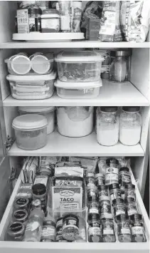  ?? CONTRIBUTE­D PHOTOS ?? Cupboards can be organized with inexpensiv­e containers and a lazy Susan. This is one of many ideas for spring cleaning.
