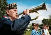  ?? Hearst Connecticu­t Media file photo ?? U.S. Navy veteran of World War II Daniel Waleski plays taps during Memorial Day observance­s in Derby.