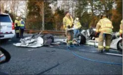  ?? THOMAS P. COSTELLO — THE ASBURY PARK PRESS VIA AP ?? Toms River firefighte­rs work at the scene of a car that crashed into a tanker truck in Toms River, N.J., Wednesday. New Jersey state police say the crash on the Garden State Parkway has left several people dead.