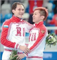  ?? DAMIEN MEYER / AGENCE FRANCE-PRESSE ?? Russia’s gold medalist, Victor Ahn (right), and silver medalist Vladimir Grigorev pose on the podium during the short track 1,000m flower ceremony at the Sochi Winter Olympics on Saturday.
