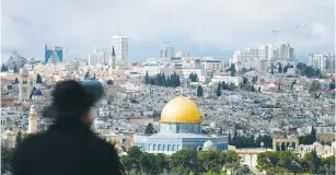  ??  ?? A MAN gazes at the Temple Mount and the Dome of the Rock.