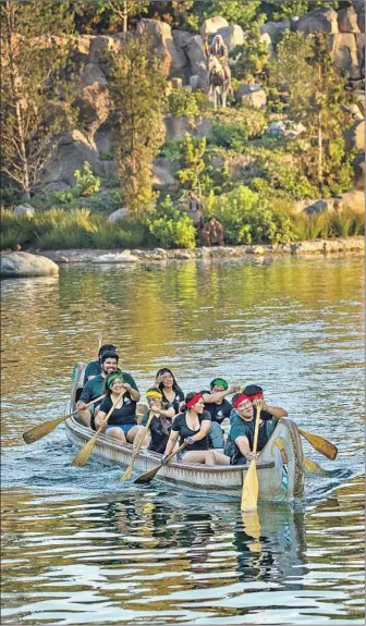  ?? Irfan Khan Los Angeles Times ?? A TEAM of Disneyland employees competes in the annual canoe-racing tournament, a seemingly frivolous perk that is popular among workers. “People feel a strong bond after these races,” one said.