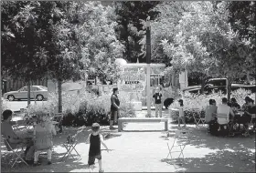  ?? AP/JOHN LUMPKIN ?? A food truck feeds ramblers in Klyde Warren Park in Dallas. The park is a great starting point for people wanting to experience the city sans car.