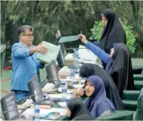  ?? AFP ?? Members of parliament cast their vote on the president’s cabinet in Tehran on Sunday. —