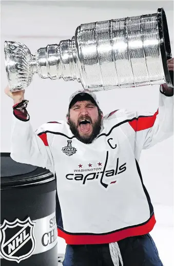  ?? ETHAN MILLER/GETTY IMAGES ?? Washington captain Alex Ovechkin hoists the Stanley Cup high above his head on Thursday night in Las Vegas after leading his team to a 4-3 victory in Game 5 to clinch the series. The Capitals’ captain was named the Conn Smythe Trophy winner.