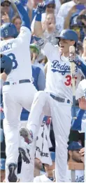  ?? GETTY IMAGES ?? The Dodgers’ Max Muncy (left) gets a high-five from Cody Bellinger after his two-run home run Monday.