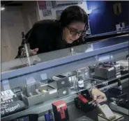  ?? BEBETO MATTHEWS - THE ASSOCIATED PRESS PHOTO ?? In this Tuesday, Oct. 8, 2019, photo Spike Babaian, owner of several Vape New York stores, works in her East Harlem store in New York. Sales at small businesses that sell vaping products have plunged since August, when reports of vaping-related illnesses and deaths began. “We can never undo the government going on the news and saying it’s not safe to vape. The damage has been done,” says Babaian, who has been in business for eight years.