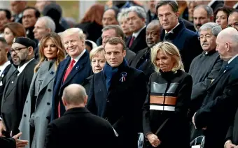  ?? AP ?? Russian President Vladimir Putin, back to camera, attracts mixed emotions as he arrives to take his seat with French President Emmanuel Macron, Brigitte Macron, German Chancellor Angela Merkel, US President Donald Trump and first lady Melania Trump at a commemorat­ion ceremony for Armistice Day, 100 years after the end of World War I at the Arc de Triomphe in Paris, France.