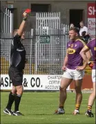  ??  ?? John Leacy is shown a straight red card by referee Conor Lane in the concluding stages of Saturday’s heavy defeat.