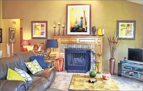  ?? ANGELA PETERSON / APETERSON@JOURNALSEN­TINEL.COM ?? Laurie Maduscha and Bob Blakely’s living room features a fireplace surrounded by a variety of art pieces.