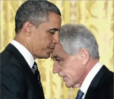  ?? Picture: REUTERS ?? ASSERTIVE: Former US Senator Chuck Hagel walks past President Barack Obama after the president announced the nomination of Hagel to be his new secretary of defence, at the White House in Washington on Monday.