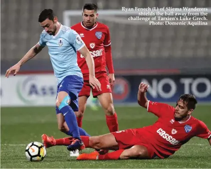  ??  ?? Ryan Fenech (L) of Sliema Wanderers shields the ball away from the challenge of Tarxien's Luke Grech. Photo: Domenic Aquilina