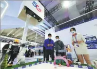  ?? LI ZHIHAO / FOR CHINA DAILY ?? Visitors try out 5G-enabled games during an expo in Guangzhou, Guangdong province.