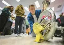  ?? ?? Micah Bickel gets his sousaphone ready to play during practice Wednesday at the school.