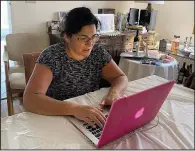  ?? (AP/Abby Hoberman) ?? Sharon Litwin, on her laptop at her home in Teaneck, N.J., is a single mother hunkering down at home with a teenage daughter. Like most people these days, Litwin only sees her friends virtually.