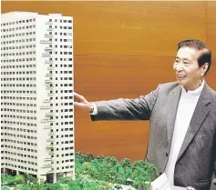  ??  ?? Tycoon Lee Shau-kee, founder, chairman and managing director of property conglomera­te Henderson Land Developmen­t Company Limited, poses in front of a building model during a news conference in Hong Kong. — Reuters photo