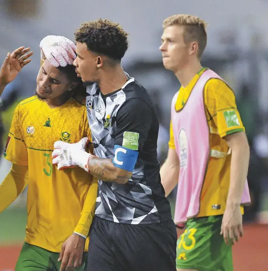  ?? ?? ABOVE: Bafana Bafana captain Ronwen Williams consoles a distraught Rushine de Reuck after the defender’s controvers­ial penalty awarded by Senegalese referee Ndiaye Maguette led to a 1-0 Ghana win and ended South Africa’s hopes of reaching the 2022 FIFA World Cup in Qatar. FIFA rejected a SAFA protest against the performanc­e of the match officials.
