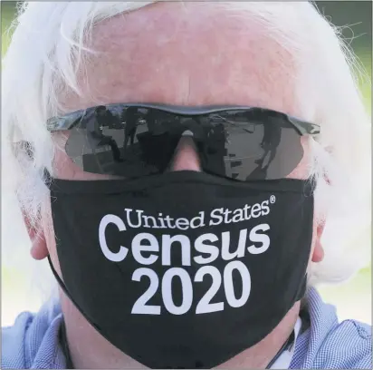 ?? THE ASSOCIATED PRESS ?? Amid concerns of the spread of COVID-19, census worker Ken Leonard wears a mask as he mans a U.S. Census walk-up counting site set up for Hunt County in Greenville, Texas, Friday, July 31, 2020.