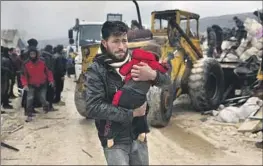  ?? Ghaith Alsayed Associated Press ?? A MAN in Syria carries the body of a young victim near the Turkish border on Monday. The death toll from the magnitude 7.8 quake is now nearly 24,000.