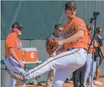  ?? KARL MERTON FERRON/BALTIMORE SUN ?? Orioles pitcher Dean Kremer, throwing during a workout on Feb. 16, won the team’s spring table tennis championsh­ip against Ryan O’Hearn.