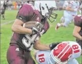  ??  ?? Mishawaka running back Blake Becker is tackled by Crown Point defensive back Trenton Schoenborn.