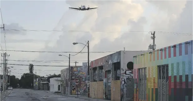  ?? JOE RAEDLE / GETTY IMAGES ?? Pesticides were sprayed over the Miami neighbourh­ood of Wynwood on Saturday in the hope of reducing the number of mosquitos, some of which may be capable of spreading the Zika virus. Spraying is one of several measures aimed at controllin­g the virus, which can cause birth defects.