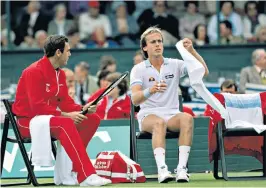  ??  ?? Hutchins, left, with John Lloyd during a break in a Davis Cup match against Australia in Adelaide