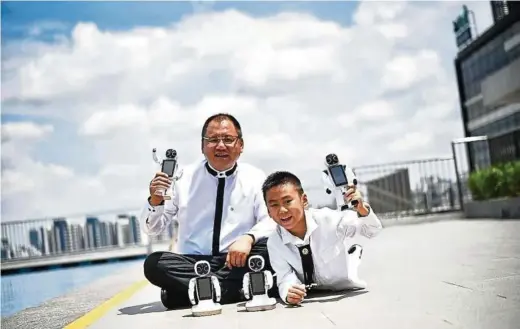  ??  ?? Emiliano (right) and his father Dr Paul Zhang. He asked his dad to build him a robot as intelligen­t as those he saw on television, one that would be able to talk and answer questions. — ANN