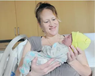  ?? JASON PAYNE/PNG ?? Born five seconds after midnight on Jan. 1 at Peace Arch Hospital in White Rock, a little boy is B.C.’s 2015 New Year’s baby, seen here with mom Darlene Henley who hasn’t picked a name yet.