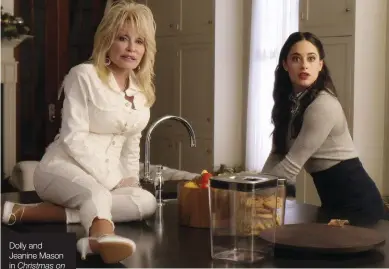  ??  ?? Dolly and Jeanine Mason in Christmas on the Square. Below left With Miley Cyrus, her goddaughte­r.