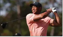  ?? (AP/Scott Audette) ?? Tiger Woods watches his tee shot on the second hole during the first round of the PNC Tournament on Saturday in Orlando, Fla. Woods and his son Charlie combined for a 62 and are tied for fifth place, three shots behind Stewart and Reagan Cink.