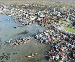  ?? TED ALJIBE / AGENCE FRANCE-PRESSE ?? This aerial photo shows destroyed houses in the town of Guiuan in Eastern Samar province, central Philippine­s, on Monday, four days after devastatin­g Typhoon Haiyan hit the country.