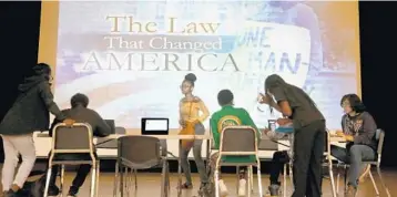  ?? MIKE STOCKER/STAFF PHOTOGRAPH­ER ?? Students sign up to vote at Blanche Ely High. Clarence Fleming, a social studies teacher at the school, said he’s never seen more enthusiasm, something he attributed largely to the Stoneman Douglas massacre.