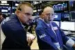  ?? RICHARD DREW — THE ASSOCIATED PRESS FILE ?? Trader Michael Milano, left, and specialist Jay Woods work Tuesday on the floor of the New York Stock Exchange.