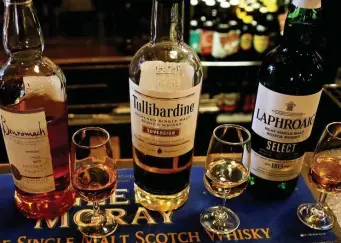  ?? AP File ?? A WEE DRAM OR THREE: Brands of scotch whisky are seen in a Glasgow bar.