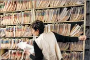  ?? HYOUNG CHANG/DENVER POST 2011 ?? An admission clerk refiles patient medical records at a clinic in Walsenburg, Colo. Electronic data breaches affected 29 million medical records between 2010 and 2013.