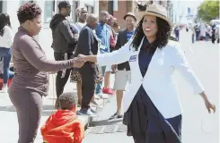  ?? STAFF FILE PHOTO BY ANGELA ROWLINGS ?? ON THE CAMPAIGN TRAIL: Boston City Councilor Ayanna Pressley greets a spectator as she campaigns for Congress during June’s Dorchester Day Parade.