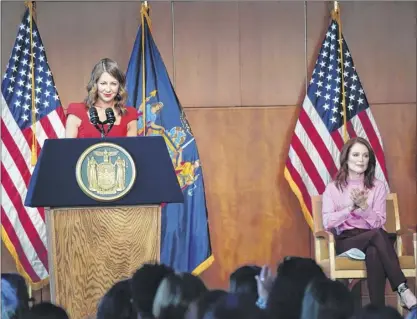  ?? Photos provided by the Office of Gov. Andrew Cuomo ?? Actress Julianne Moore, right, listens as Secretary to the Governor Melissa Derosa, chair of the New York State Council on Women and Girls, unveils the administra­tion’s proposals to improve the lives of women in New York on Tuesday at Lincoln Center in Manhattan.