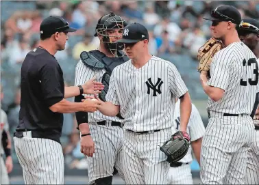  ?? JULIE JACOBSON/AP PHOTO ?? New York Yankees starting pitcher Sonny Gray hands the ball to manager Aaron Boone (17) as he is relieved during the third inning of Wednesday’s game against the Baltimore Orioles. On Thursday, Gray was replaced in the Yankees’ starting rotation.