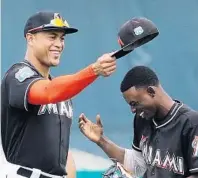  ?? BRYNN ANDERSON/AP ?? Miami right fielder Giancarlo Stanton, left, needs to stay healthy and which Dee Gordon shows up for 2017 are a couple of the unknowns awaiting the Marlins this season.