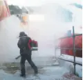  ?? Doug Mills / New York Times ?? A worker blows snow near the Alpine course, which has been beset by strong winds.