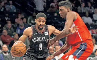  ?? Anthony J Causi ?? EARNING HIS PAY: Point guard Spencer Dinwiddie scored 27 points to help the Nets beat the Wizards on Friday, a day after signing a new three-year, $34 million contract.