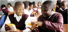  ?? AYANDA NDAMANE African News Agency (ANA) ?? Luyanda Fumaniso and Lutho Londile trying to switch on the solar lights. Marconi Beam Primary School pupils received a donation of 1 730 solar lights that will help them study at night. | STAFF WRITER