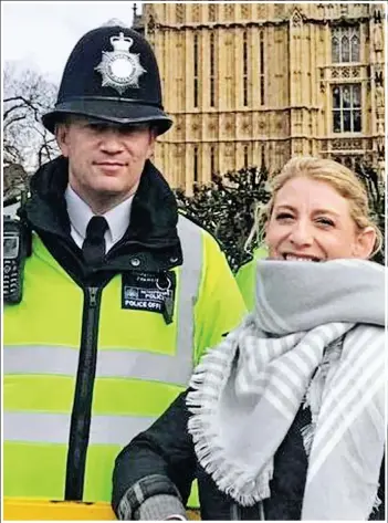  ??  ?? Poignant: Pc Keith Palmer poses with a tourist in a photograph taken 45 minutes before he was stabbed to death in the grounds of Parliament by terrorist Khalid Masood. American Staci Martin, right, shared the “last picture” of the brave officer as an...