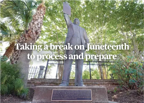  ?? DAVID J. PHILLIP/AP ?? A statue in Galveston, Texas, depicts a man holding the state law that made Juneteenth a state holiday in 1979.